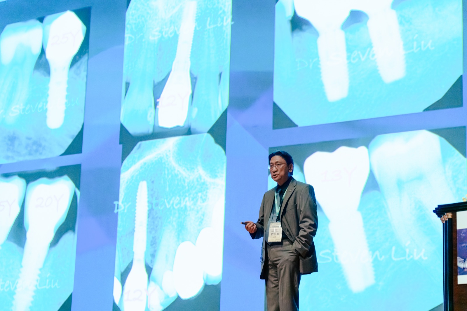 Dr. Steven Liu presenting radiographs of dental implants still in function after 12, 13, 20 and 25 years